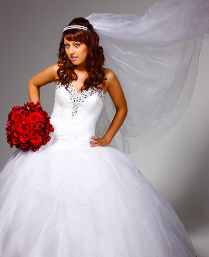 Bridal portrait — flowing gown beside studio architecture